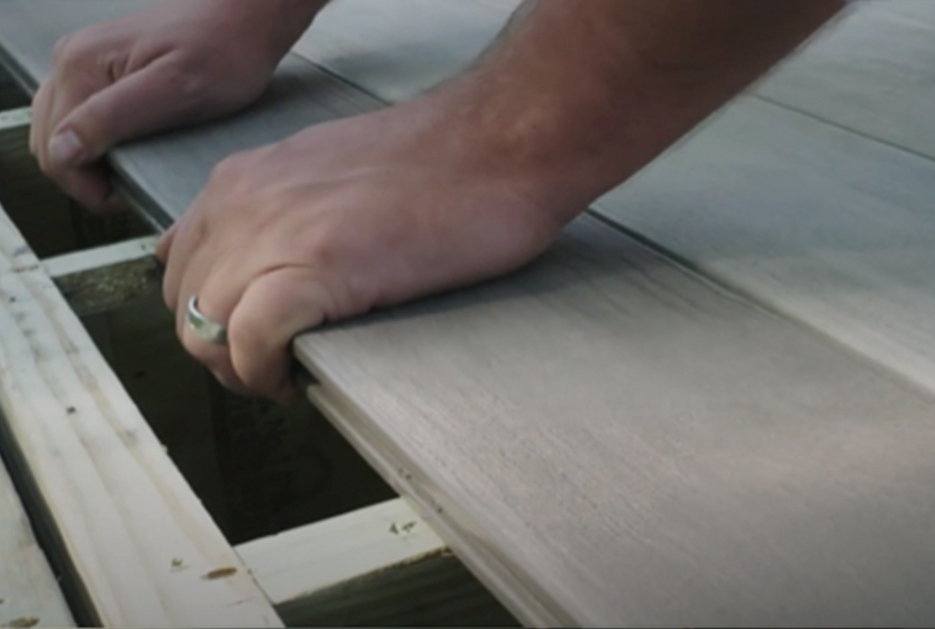 Person laying deck boards